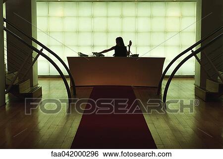 Stock Photograph - "Office reception, receptionist at desk answering phone". Fotosearch