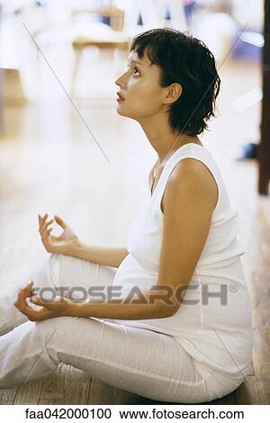 "Pregnant woman meditating on floor, side view" View Large Photo Image Stock Image - "Pregnant woman meditating on floor, side view". Fotosearch