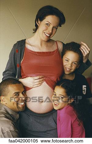 "Pregnant woman with family, daughter and husband leaning against her stomach" View Large Photo Image Stock Photography - "Pregnant woman with family, daughter and husband leaning against her stomach". Fotosearch