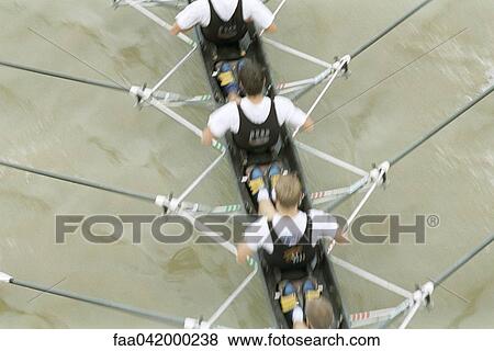 Stock Photo - "Rowing team rowing scull, cropped view". Fotosearch