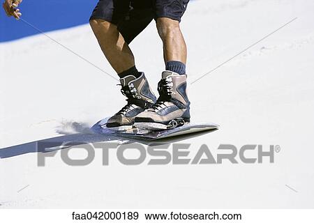 "Sandboarder sliding down dune, close-up of feet on board" View Large Photo Image Stock Photo - "Sandboarder sliding down dune, close-up of feet on board". Fotosearch