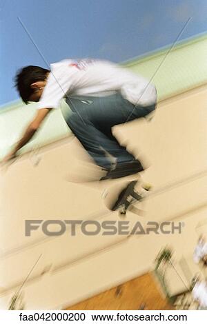 Skateboarder doing midair trick View Large Photo Image Stock Image - Skateboarder doing midair trick. Fotosearch