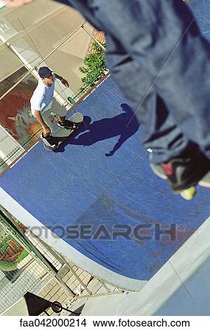 "Skateboarder skating up side of ramp, high angle view" View Large Photo Image Picture - "Skateboarder skating up side of ramp, high angle view". Fotosearch