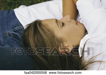 Stock Photo - "Woman asleep with head resting on man's stomach, cropped". Fotosearch