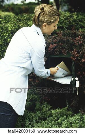 Stock Photo - Woman checking mail. Fotosearch