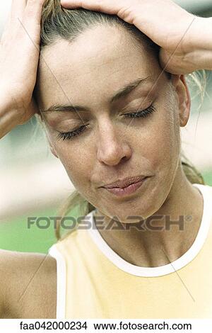 "Woman holding head, eyes closed, close-up" View Large Photo Image Picture - "Woman holding head, eyes closed, close-up". Fotosearch