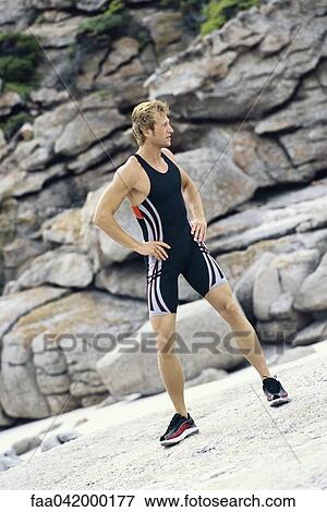 Young man with hands on hips doing stretches outdoors View Large Photo Image Stock Photo - Young man with hands on hips doing stretches outdoors. Fotosearch
