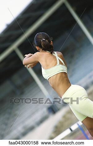 Athletic woman stretching outdoors View Large Photo Image Stock Photo - Athletic woman stretching outdoors. Fotosearch
