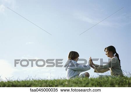 Brother and sister playing clapping game outdoors View Large Photo Image Stock Photography - Brother and sister playing clapping game outdoors. Fotosearch