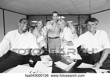 Business associates celebrating with champagne in office View Large Photo Image Stock Photograph - Business associates celebrating with champagne in office. Fotosearch