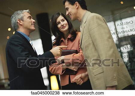 Stock Photo - Business associates chatting. Fotosearch