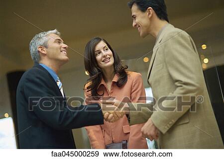 Stock Photo - Business associates shaking hands. Fotosearch