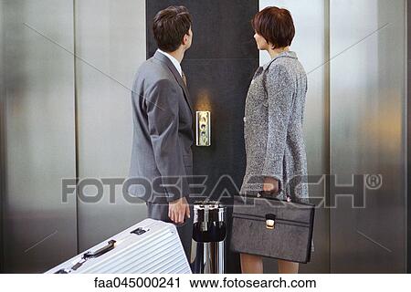 Business associates waiting for elevator View Large Photo Image Stock Image - Business associates waiting for elevator. Fotosearch