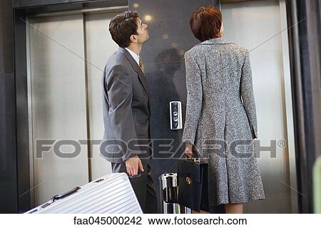 Business associates waiting for elevator View Large Photo Image Stock Image - Business associates waiting for elevator. Fotosearch