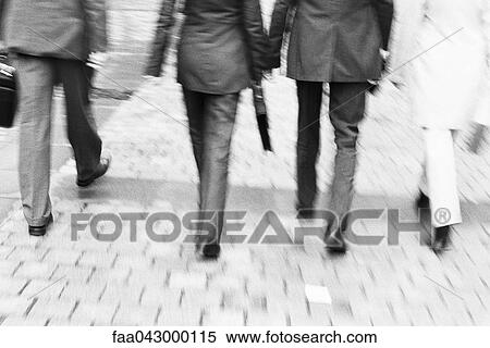 Business professionals walking together along sidewalk, rear view, waist down View Large Photo Image Stock Photography - Business professionals walking together along sidewalk, rear view, waist down. Fotosearch