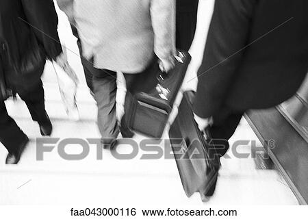 Business professionals with briefcases descending stairs View Large Photo Image Stock Photograph - Business professionals with briefcases descending stairs. Fotosearch