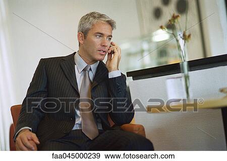 Stock Photo - Businessman talking on cell phone. Fotosearch