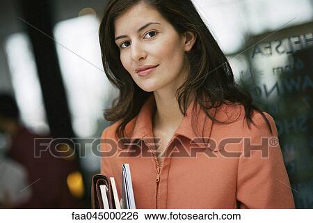 Stock Photograph - Businesswoman smiling at camera, portrait. Fotosearch