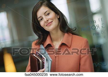 Businesswoman smiling at camera, portrait View Large Photo Image Stock Photography - Businesswoman smiling at camera, portrait. Fotosearch