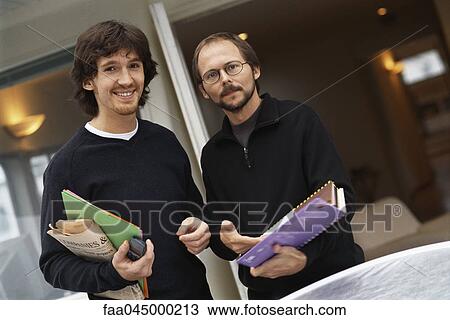Casually dressed colleagues smiling at camera View Large Photo Image Stock Image - Casually dressed colleagues smiling at camera. Fotosearch