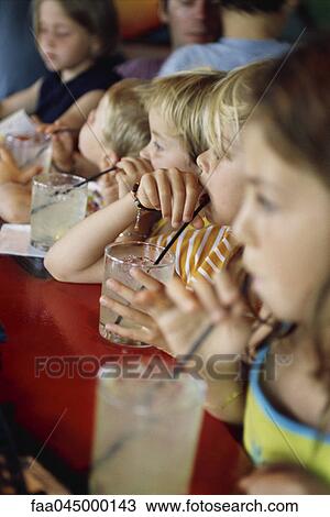 Stock Image - Children at snack-time. Fotosearch