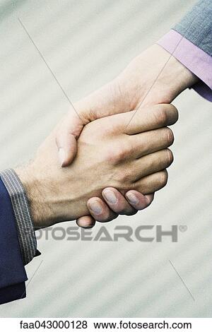 Confident handshake between professionals View Large Photo Image Stock Photo - Confident handshake between professionals. Fotosearch