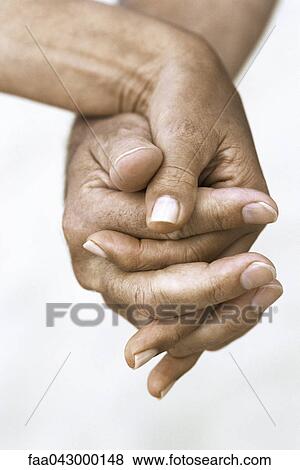 Stock Photo - Couple holding hands, cropped view. Fotosearch