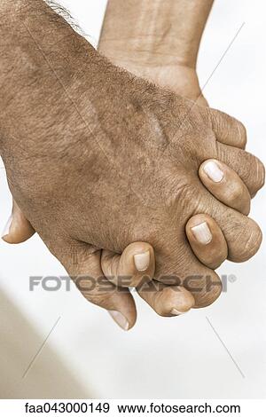 Stock Photo - Couple holding hands, cropped view. Fotosearch