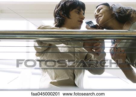 Couple listening to cell phone together View Large Photo Image Stock Image - Couple listening to cell phone together. Fotosearch