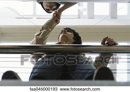 Friends looking at each other bumping fists View Large Photo Image Stock Image - Friends looking at each other bumping fists. Fotosearch