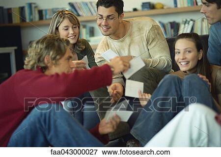 Friends sharing photos with one another View Large Photo Image Stock Photo - Friends sharing photos with one another. Fotosearch