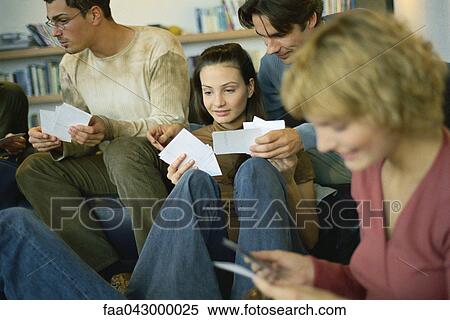 Stock Photography - Friends sharing photos with one another. Fotosearch