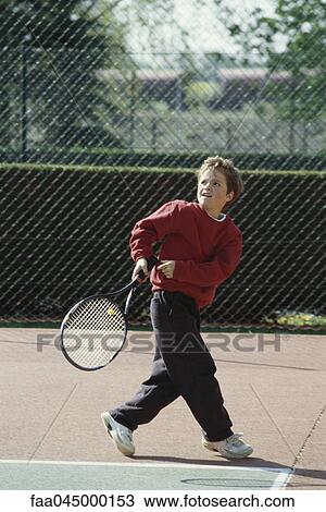 Stock Image - Girl playing tennis. Fotosearch