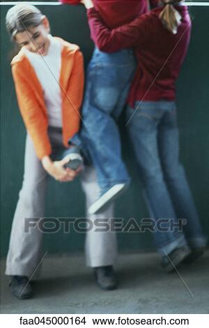 Picture - Girls lifting friend to look out window, cropped. Fotosearch