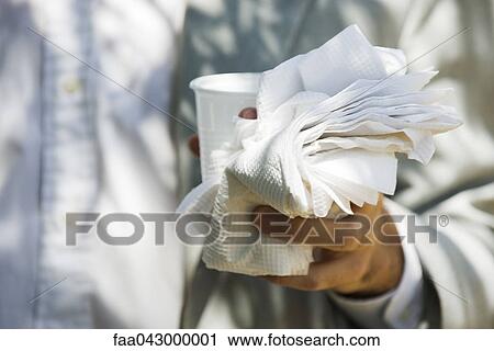 Hand holding disposable cup, paper napkins View Large Photo Image Stock Image - Hand holding disposable cup, paper napkins. Fotosearch