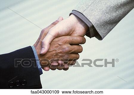 Stock Photo - Handshake between professionals. Fotosearch