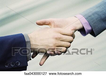 Hesitant handshake between professionals View Large Photo Image Stock Photo - Hesitant handshake between professionals. Fotosearch