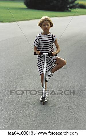 Little girl riding push scooter View Large Photo Image Stock Photography - Little girl riding push scooter. Fotosearch