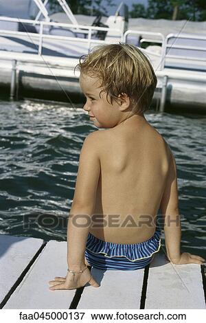 Little girl sitting on pier looking away View Large Photo Image Stock Photo - Little girl sitting on pier looking away. Fotosearch