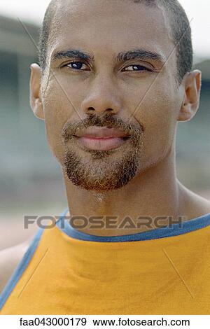 Stock Photo - Man with goatee smiling at camera, portrait. Fotosearch