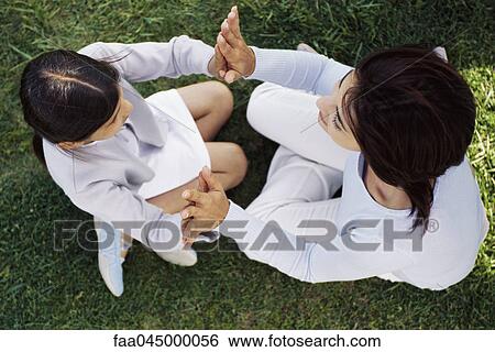 Mother and daughter playing clapping game, viewed from directly above View Large Photo Image Stock Photograph - Mother and daughter playing clapping game, viewed from directly above. Fotosearch