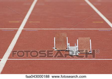Stock Photo - Starting blocks on running track. Fotosearch