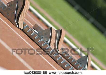 Stock Photograph - Starting blocks on running track. Fotosearch