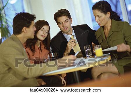 Picture - Team of associates collaborating in cafe. Fotosearch