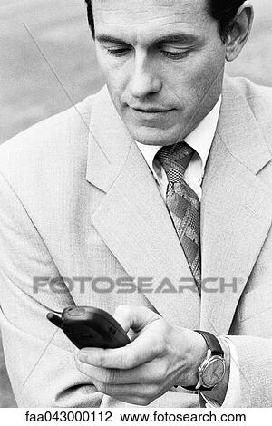 Well dressed man text messaging on cell phone View Large Photo Image Stock Image - Well dressed man text messaging on cell phone. Fotosearch