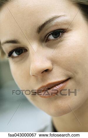 Stock Photo - Woman confidently looking at camera. Fotosearch
