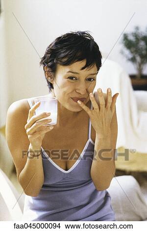 Woman drinking glass of milk View Large Photo Image Picture - Woman drinking glass of milk. Fotosearch