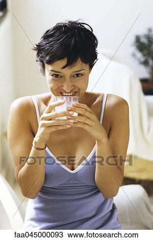 Stock Image - Woman drinking glass of milk. Fotosearch