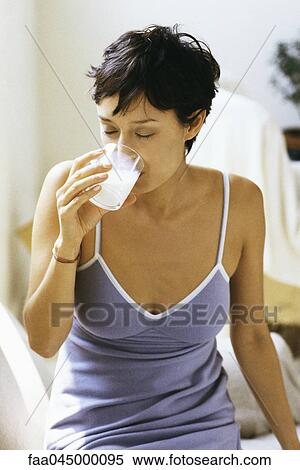 Woman drinking glass of milk View Large Photo Image Stock Photography - Woman drinking glass of milk. Fotosearch