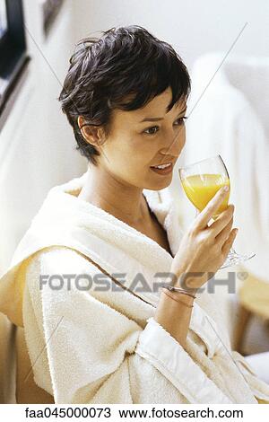 Woman in bathrobe drinking orange juice View Large Photo Image Stock Image - Woman in bathrobe drinking orange juice. Fotosearch